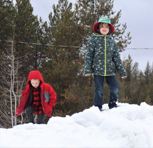 Snow piles are for playing. Photo by LibbyMT.com.