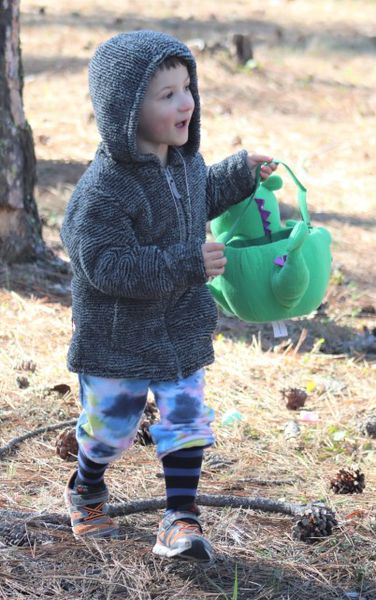 A happy guy with his dino bucket. Photo by LibbyMT.com.