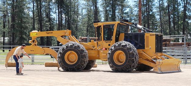 Checking out the really big skidder. Photo by LibbyMT.com.