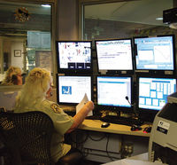 Dispatcher Charlene Williamson handles a call in the county�s 911 center. Photo by Kootenai Valley Record.