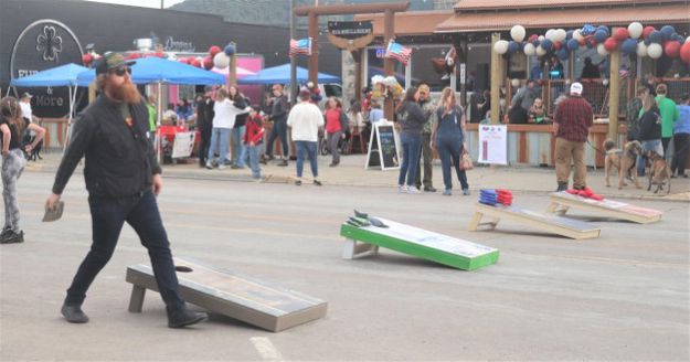 Cornhole practice. Photo by LibbyMT.com.